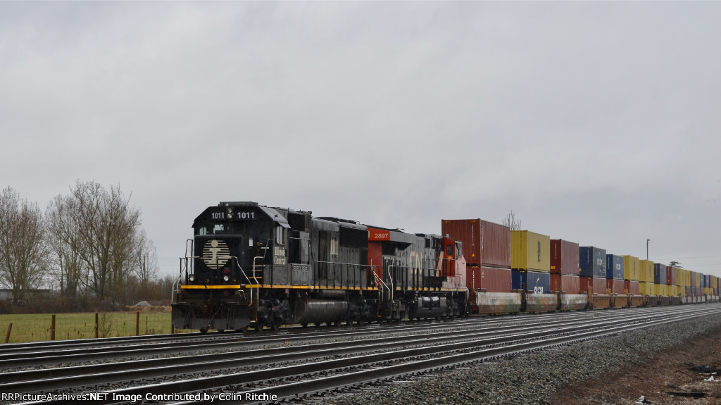 Death Star IC 1011 lead of a CN unit stack train, waiting for crew in Fisher Siding, to head E/B.